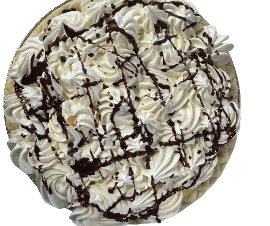 Homemade pie with whipped cream and chocolate drizzle
